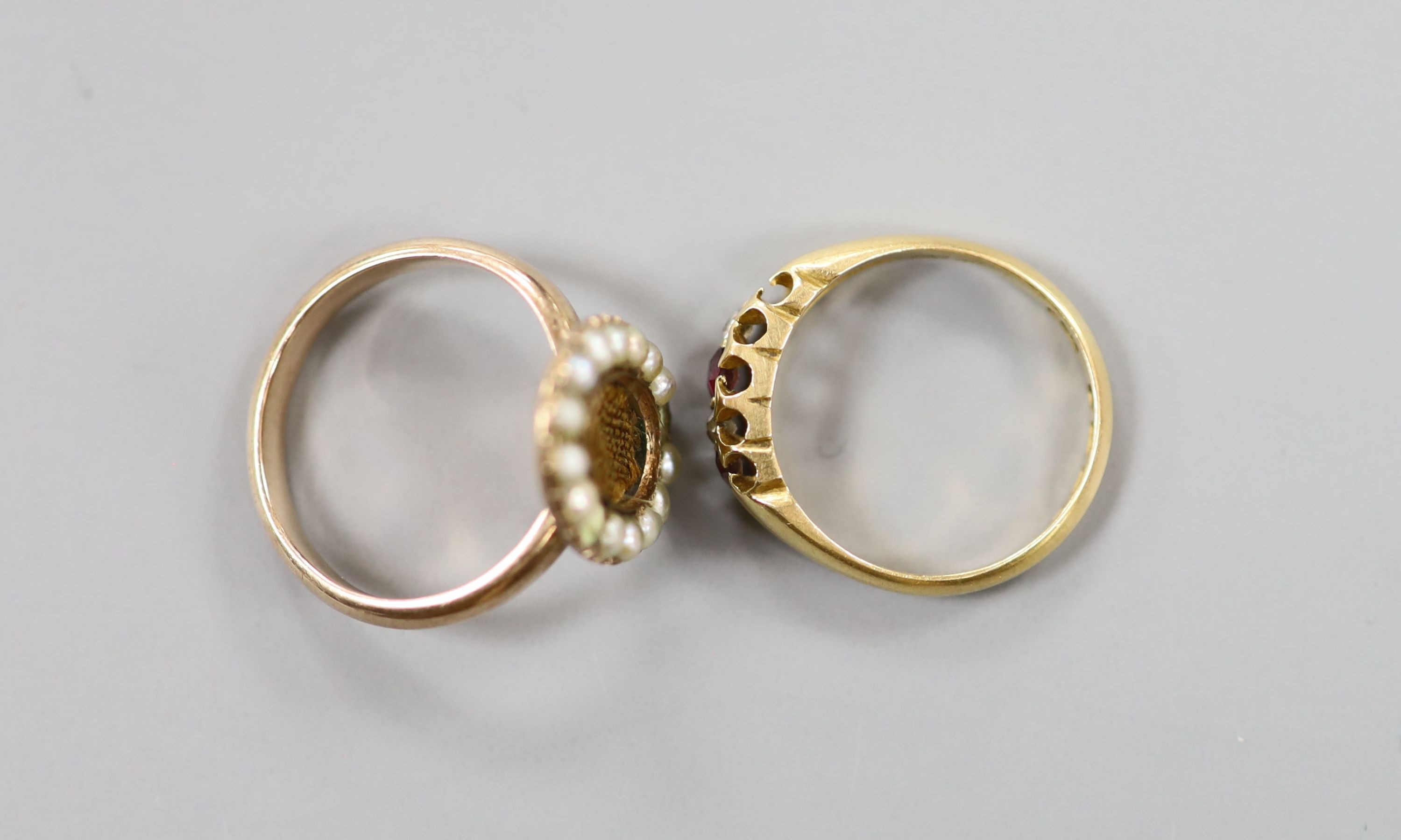 A Victorian 15ct gold, ruby and diamond set half hoop ring (stone missing), size M, gross 3.5 grams and a 19th century yellow metal and seed pearl set mourning ring, with plaited hair (glazed panel missing & two pearls m